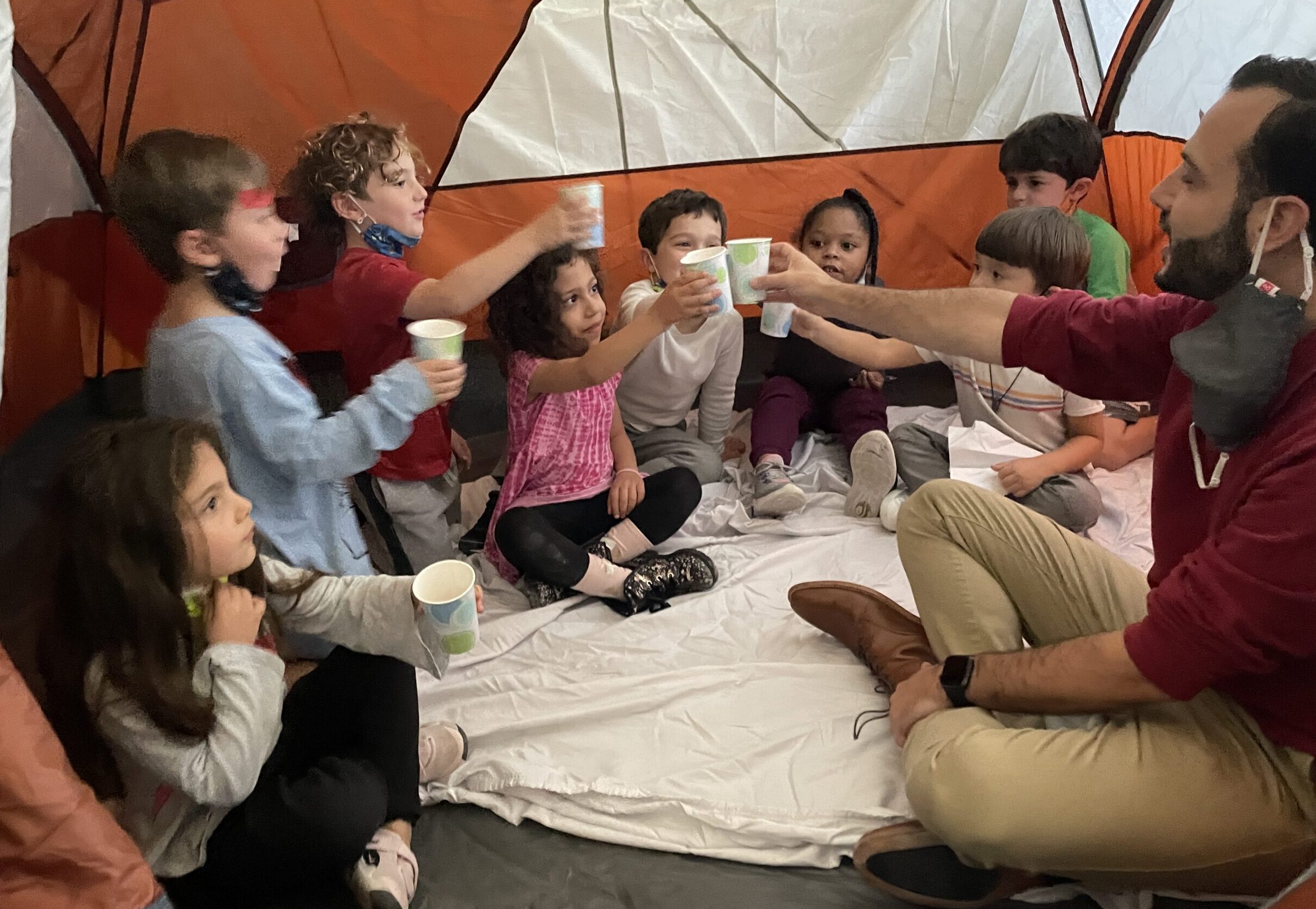 Rabbi Alex welcomes our Pre-K class to his tent as they learn about hachnasat orchim (hospitality)